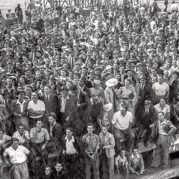 A picture of a very large crowd of dockside onlookers, taken from the SS Partizanka as it docks in Fremantle on its way to Sydney.